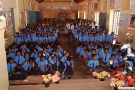 Assembled school children and their parents
